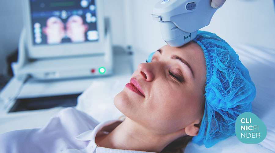 Patient receiving an aesthetic ultrasound treatment to the face in a clinic