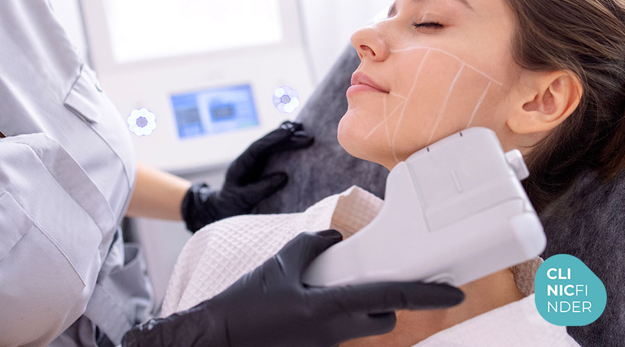 Practitioner holding an ultrasound treatment handpiece against a patient’s lower face
