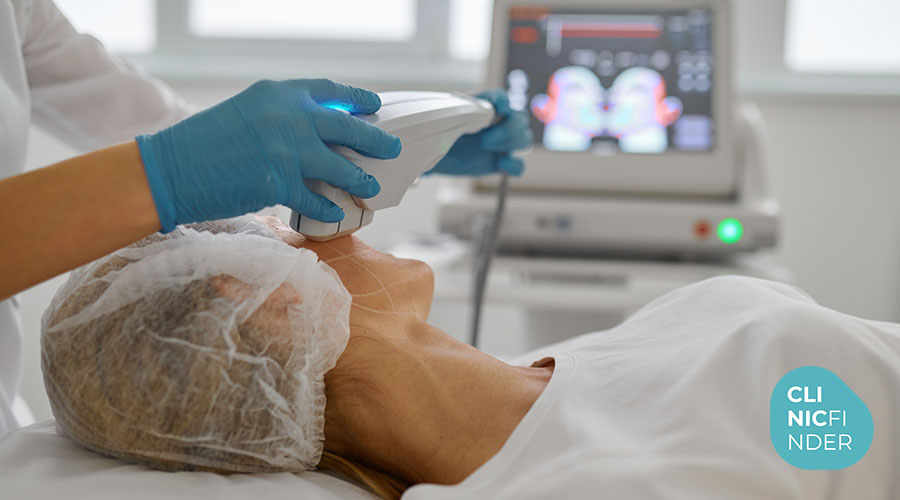 Practitioner applying an ultrasound handpiece along a patient’s jaw and neck
