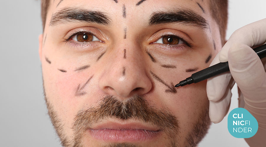 Practitioner marking planned facial treatment areas before an aesthetic procedure