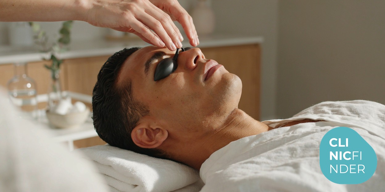 Patient wearing opaque protective eye shields on a treatment couch before a light-based hair removal session