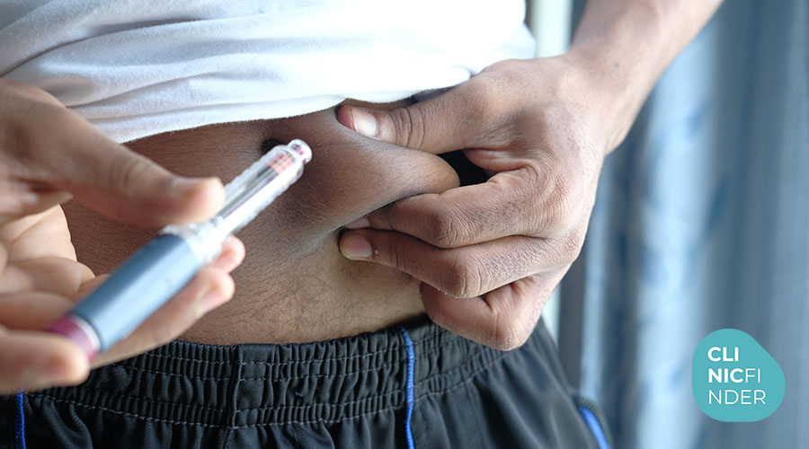 Practitioner making a local injection into abdominal tissue