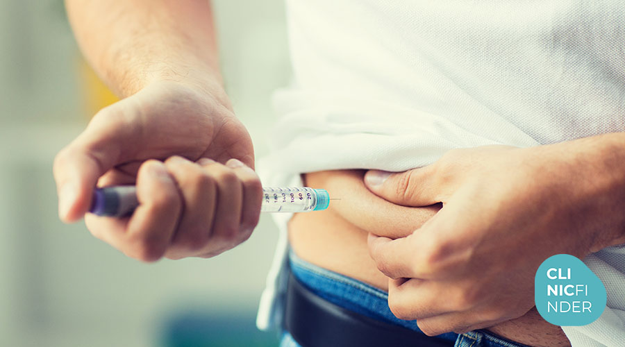 Person administering a prescribed injection into the abdomen